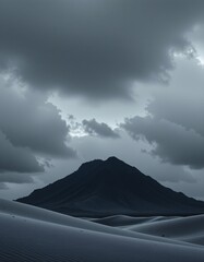 Fototapeta premium Solitary Mountain Over Sand Dunes Under Stormy