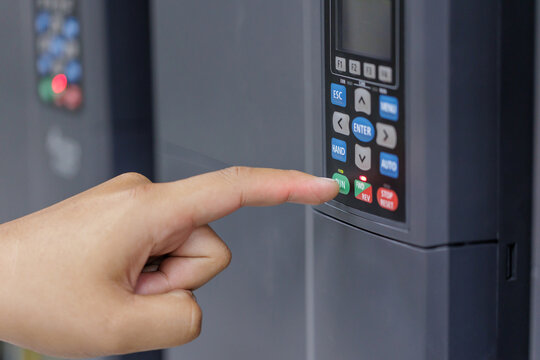 Hand Pressing Button on VFD Control Panel