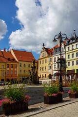 beautiful market square with Holy Trinity monument in old town Bystrzyca Klodzka, Poland
