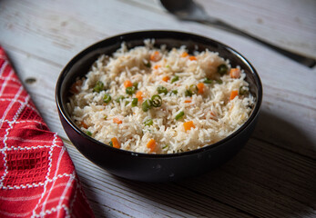 Vegetable pulao or basmati rice made with vegetables served in a bowl. Close up, selective focus.