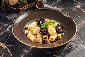 Creamy rigatoni pasta served with grilled mushrooms and parmesan