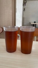 A glass of Ice lemon tea on the wooden table