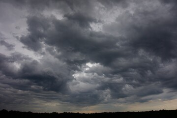 Obraz premium Clouds over the forest in summer