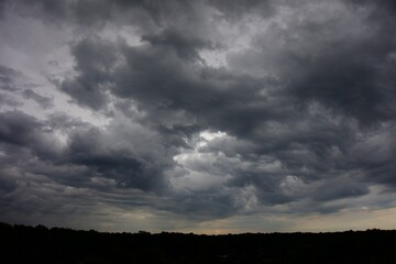 Obraz premium Clouds over the forest in summer