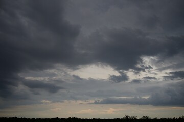 Fototapeta premium Clouds over the forest in summer