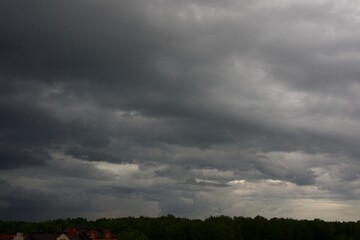 Obraz premium Clouds over the forest in summer