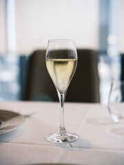 Elegant Glass of Champagne on White Tablecloth in Fine Dining Restaurant