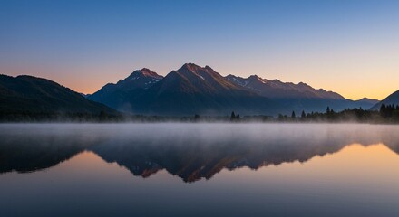 Naklejka premium Serene Sunrise Reflection: Misty Mountain Lake at Dawn - A breathtaking panoramic view of a tranquil mountain lake at sunrise, with a thick layer of morning mist gently rising above the water's sur...