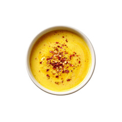 Creamy Yellow Soup with Red Pepper Flakes in a White Bowl