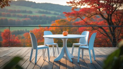 Fototapeta premium A table with four chairs on a balcony overlooking autumn-colored trees with hills in the background.