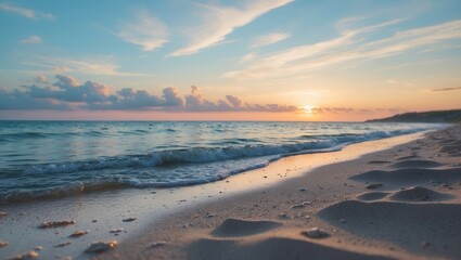 Fototapeta premium Sunset over the ocean from the beach with waves lapping the shore. Tranquil and scenic, capturing a peaceful seaside view.