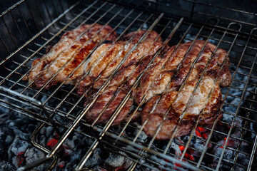 A plate of meat with spices on top. The meat is cooked and has a nice brown color