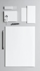 Blank stationery arrangement sits neatly on a gray surface, providing a clean and professional aesthetic for branding or presentation purposes.