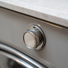 Obraz premium Close up of a silver metal dial knob with textured grip on a brushed stainless steel appliance panel