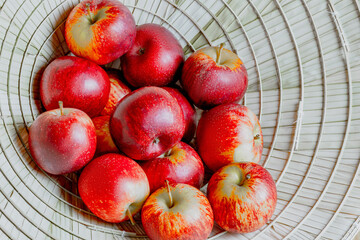 Red and yellow apples in basket: fresh ripe fruit arrangement