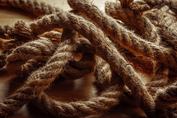Close-up of coiled hemp ropes on wooden surface