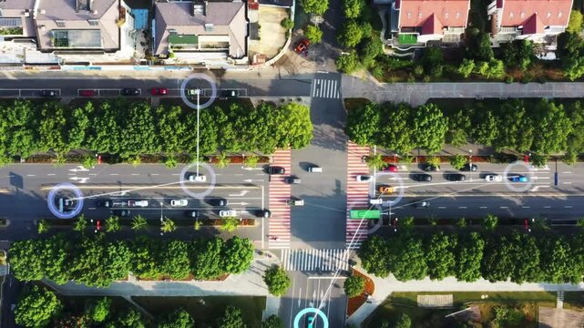A top-down aerial view of a city intersection with futuristic digital overlays, visualizing autonomous vehicles communicating to navigate traffic safely through a smart network. - Powered by Adobe