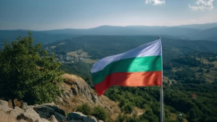 On Independence Day, the Bulgaria flag waves proudly against a vibrant mountainous backdrop.