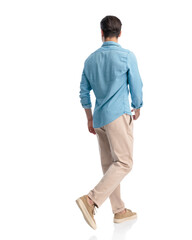 back and side view of young fashion man looking to side and walking