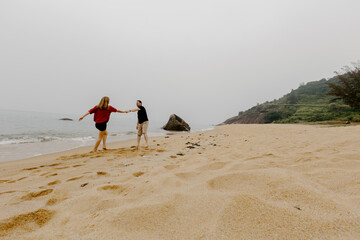 Young couple enjoys overcast day at serene beach