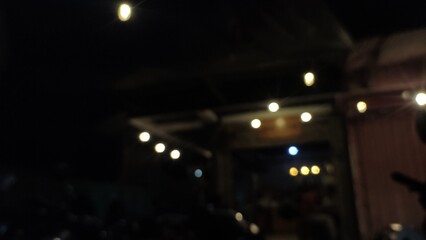 Night photo of warm glowing lights creating a cozy atmosphere in the dark. This image captures a...