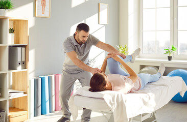 Woman undergoes a physiotherapy session with a therapist massaging leg, focusing on knee...