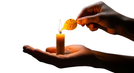 Hand lighting a glowing candle, symbolizing hope, faith, and remembrance for spiritual vigils or festive celebrations like Christmas, Diwali, and Hanukkah,