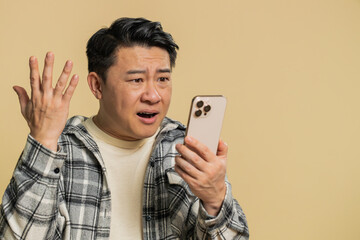 Upset sad Asian man use smartphone typing browsing, play game, loses, surprised by sudden lottery...