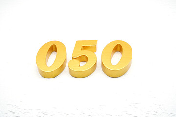 The numbers are made of gold-painted wood, placed on a white background.