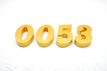 The numbers are made of gold-painted wood, placed on a white background.