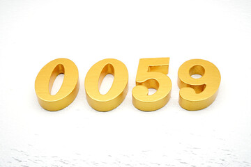 The numbers are made of gold-painted wood, placed on a white background.