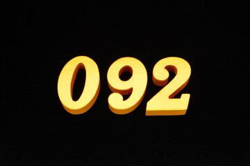 The numbers are made of gold-painted wood, placed on a black background.
