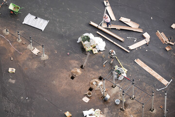 Aerial view of construction workers installing outdoor gym equipment and metal bars on asphalt...