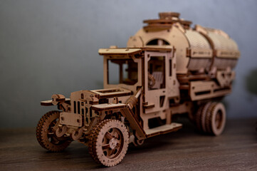 Wooden vintage truck model, laser-cut panels, layered plywood, warm studio lighting, macro shot,...