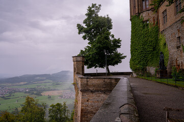 Panoramic view from the terrace of a historic European castle on a cloudy day. A medieval fortress...