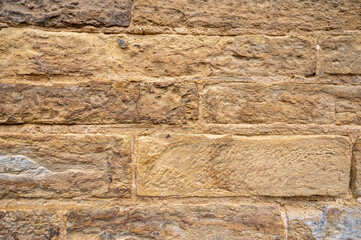 Rough texture of an old sandstone wall. Rustic stone block background. Concept of history,...