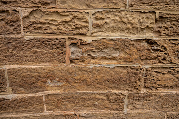 Rough texture of an old sandstone wall. Rustic stone block background. Concept of history,...