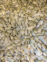 Raw pumpkin seeds in bulk. Natural seed and healthy food background.