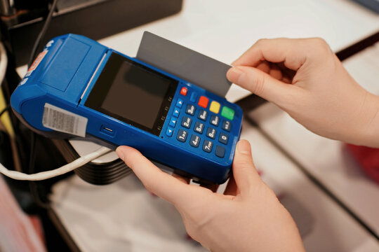Person using a payment terminal to process a card transaction