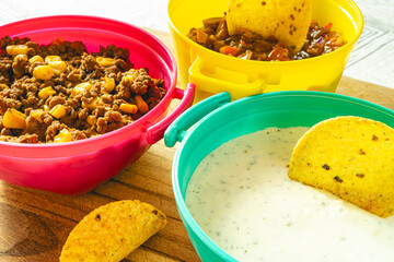 Mexican food in colorfull Bow's. Nachos with meat