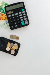 Calculator with Dollar and Shekel Banknotes on Desk