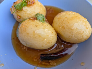 Fried Boiled Egg with Tamarind Sauce or Son-in-law’s Eggs. Thai food close-up image.