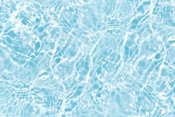 Blue water with ripples on the surface. Defocus blurred transparent blue colored clear calm water surface texture with splashes and bubbles. Water waves with shining pattern texture background.