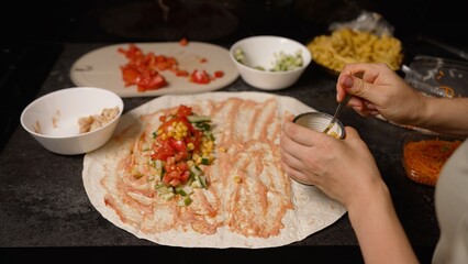 Chef preparing a delicious vegetarian wrap with fresh ingredients