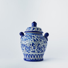 Blue and white ceramic ginger jar with ornate floral pattern and lid