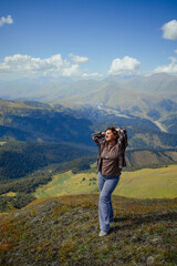 Happy woman enjoying freedom and fresh air on mountain top, relaxing in nature with scenic landscape view, travel and wellness lifestyle inspiration outdoors