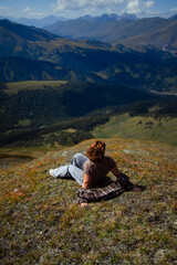 Fototapeta premium Happy woman enjoying freedom and fresh air on mountain top, relaxing in nature with scenic landscape view, travel and wellness lifestyle inspiration outdoors