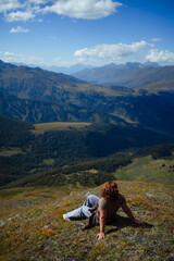 Naklejka premium Happy woman enjoying freedom and fresh air on mountain top, relaxing in nature with scenic landscape view, travel and wellness lifestyle inspiration outdoors