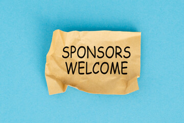 Sponsors Welcome concept. The message Sponsors Welcome on a sticky note paper on blue background