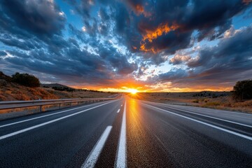 Naklejka premium Empty highway at sunset with dramatic clouds